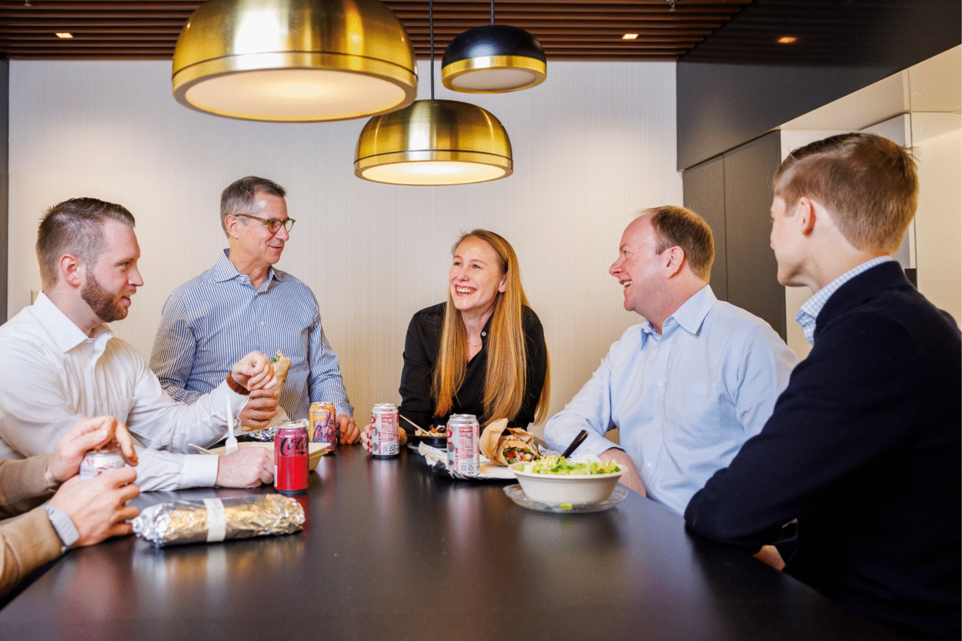 Staff team discussing strategies during a meeting in a professional setting.