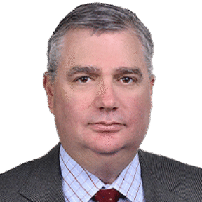 A middle-aged man with short gray hair, wearing a gray suit, light blue checkered shirt, and red polka dot tie, poses against a plain white background—professional attire typical of a Houlihan Lokey financial advisory expert.