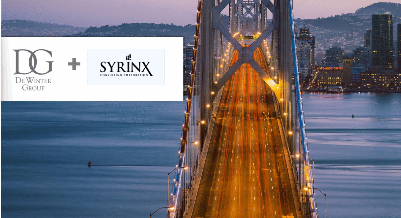 A view of a lit suspension bridge at dusk with city buildings in the background. On the left, DeWinter Group and Syrinx Consulting logos are shown side by side with a plus sign, highlighting their recent acquisition.