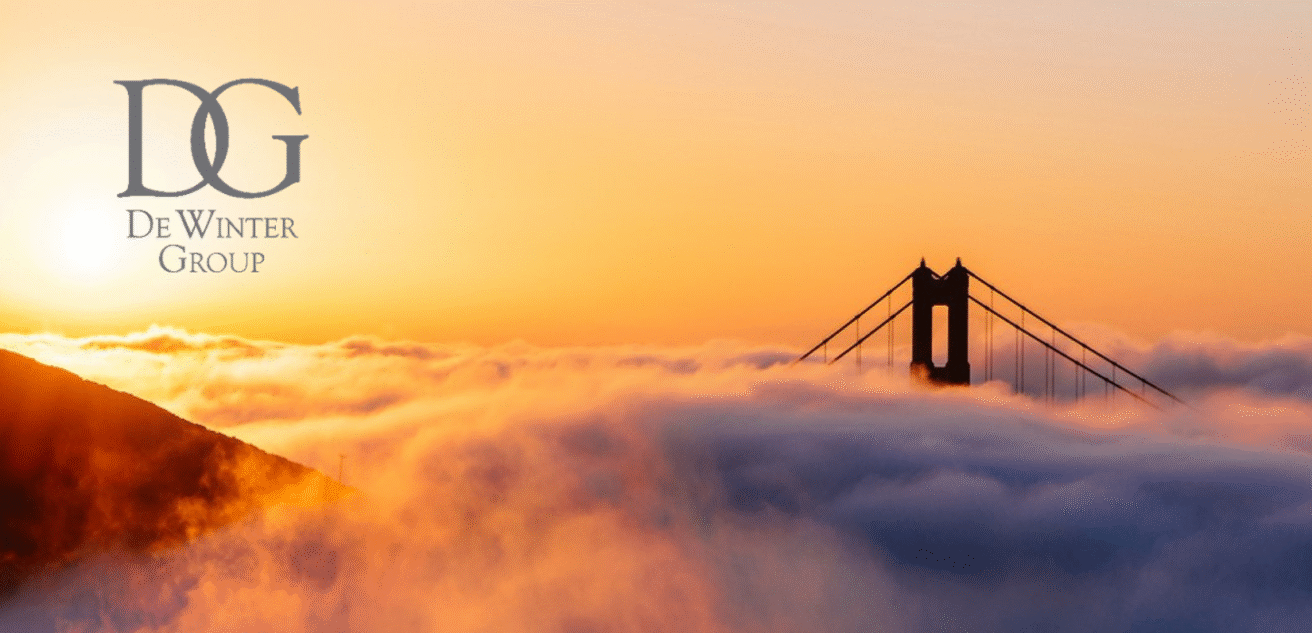 The sun sets behind a fog-covered Golden Gate Bridge, with the DeWinter Group and Heritage Capital logos and names in gray text on the upper left corner.