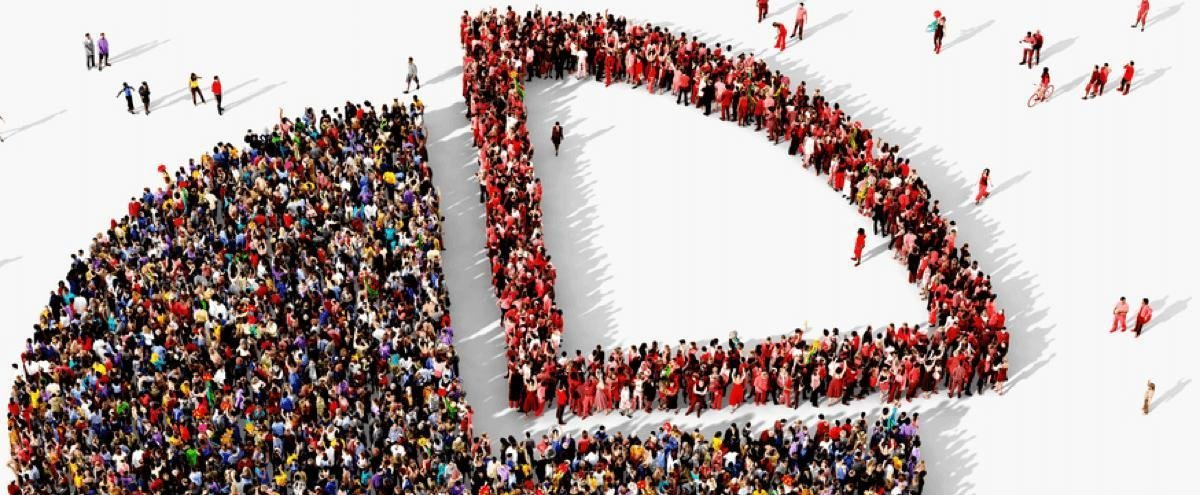 A large group of people forms the shape of a pie chart on a white background, with different sections represented by clusters—highlighting the concept of Minority Investing as envisioned by Charlie Gifford.