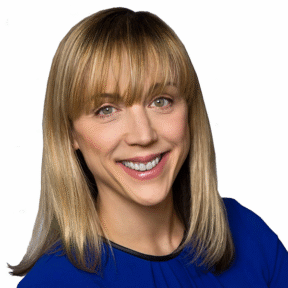 A smiling woman with straight blonde hair and bangs, wearing a royal blue top, is pictured against a plain white background.