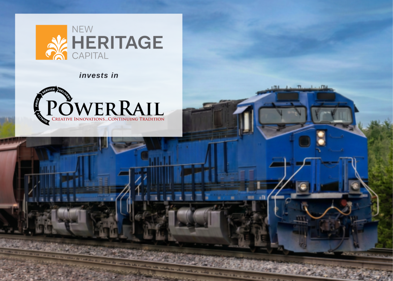 A blue freight train moves on tracks. Overlaid text reads, “New Heritage Capital forms a Strategic Partnership with PowerRail. Creative Innovations. Continuing Tradition.”.